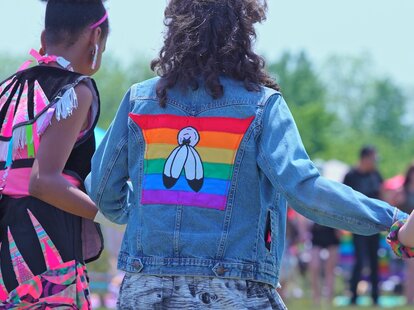 Annual Two Spirit Pow wow, by 2-Spirited People of the 1st Nations. Circle of friendship or friendship dance. A person with Two spirit pride flag on the back: Toronto, Ontario, Canada - May 27, 2023.