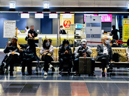 Passengers at the Japan Airlines (JAL) departure lounge of Haneda International Airport