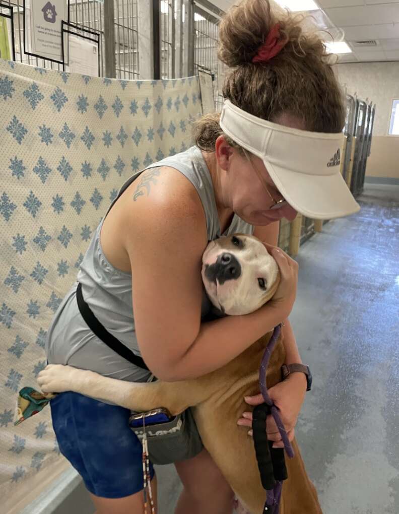 dog hugging woman 