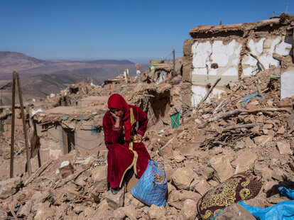 A woman sits amongst the rubble of her village that was almost completely destroyed by Friday’s earthquake, on September 11, 2023 in Douzrou, Morocco.