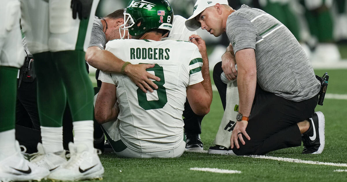 Aaron Rodgers injures his left Achilles tendon in his first series for the  Jets