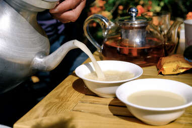 kettle pouring butter tea into two cups
