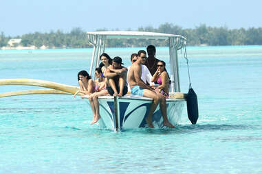 kardashian family riding a boat on the turquoise waters of bora bora