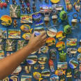 Hand reaching for Goa tourism magnets 