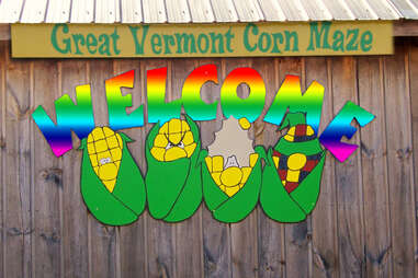 rainbow sign that says "great vermont corn maze welcome"