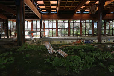a lawn chair in an abandoned pool area