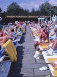 People tanning by the pool at a Catskills resort