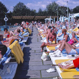 People tanning by the pool at a Catskills resort
