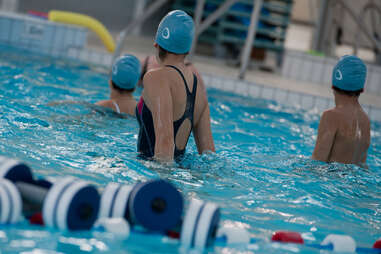 swimmers wearing caps in a pool