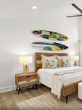 A bedroom in a Hilton Head Vrbo rental with surf boards as the headboard. 