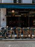 Cozy street with tables of cafe in Paris, France. Cityscape of Paris.