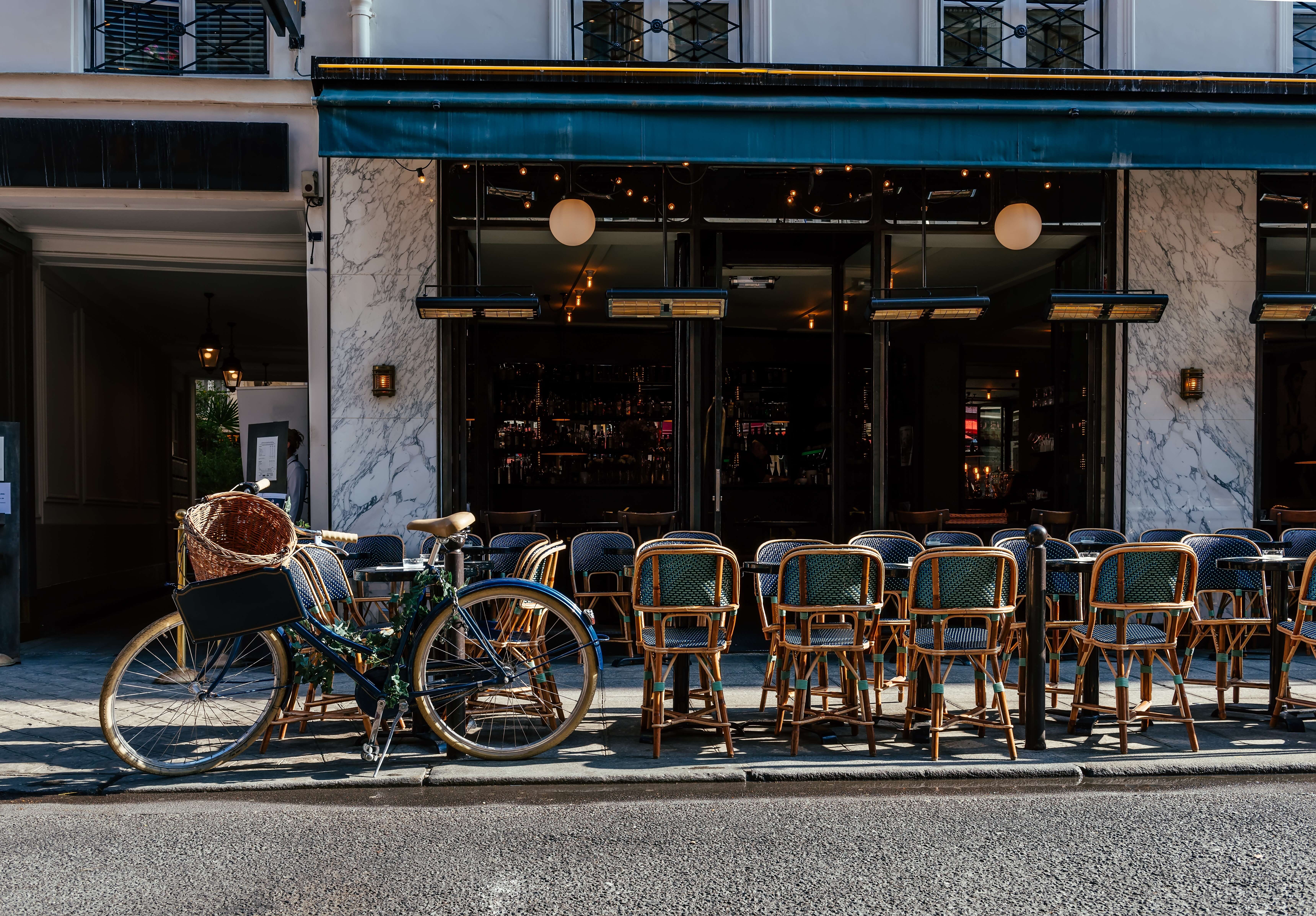 Cozy street with tables of cafe in Paris, France. Cityscape of Paris.