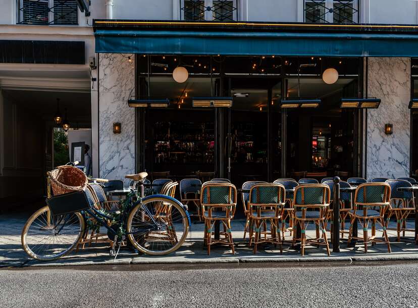 Cozy street with tables of cafe in Paris, France. Cityscape of Paris.