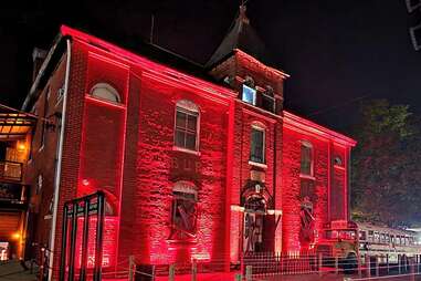 facade of dent schoolhouse lit up in red light