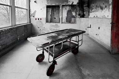 hospital gurney in abandoned asylum 