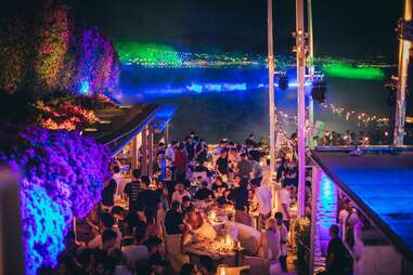 crowd of partygoers at island athens riviera with backdrop of ocean