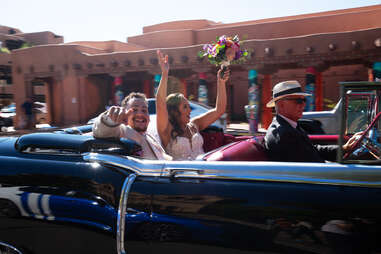 newly married couple in car show parade