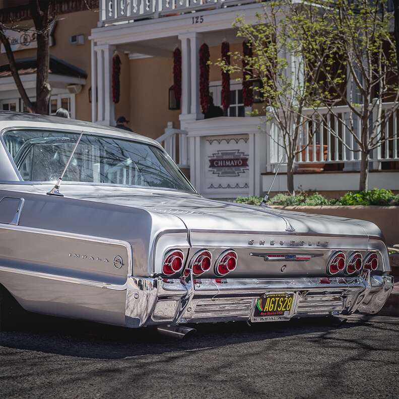 silver chevy impala lowrider in front of hotel chimayo, santa fe
