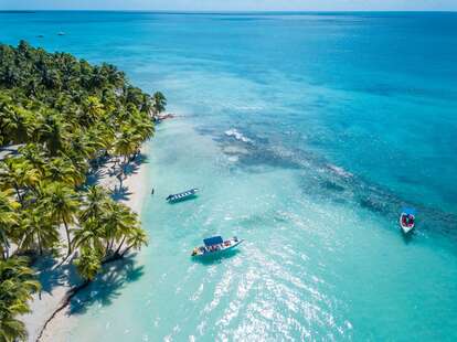 Aerial view of Saona Island in Dominican Republuc. Caribbean Sea with clear blue water and green palms. Tropical beach.