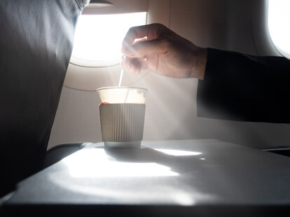 Holding coffee cup on an airplane