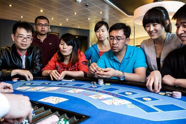 friends enjoying poker on ferry