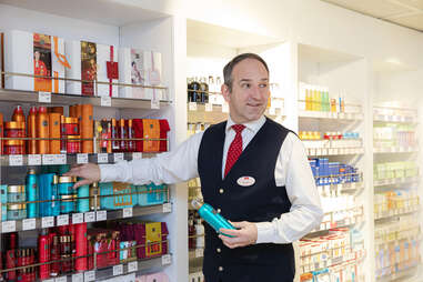 stena line crew member stocks the shelves inside duty free shop on ferry