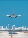 Airplane about to land at Miami International Airport with Downtown Miami skyline. 