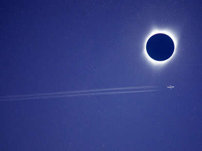 plane flying during eclipse