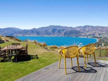 A view of a bright blue lake in Hawea, New Zealand, from an Airbnb listing. 