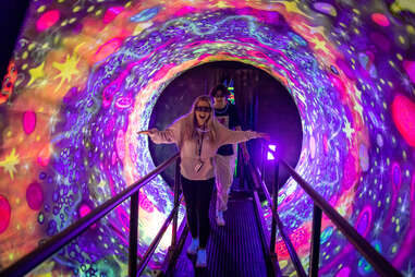 people walking in a psychedelic tunnel