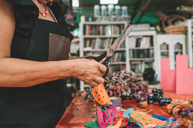 woman cutting colorful skull garland