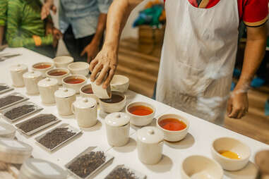 men conducting a tea tasting at darjeeling factory