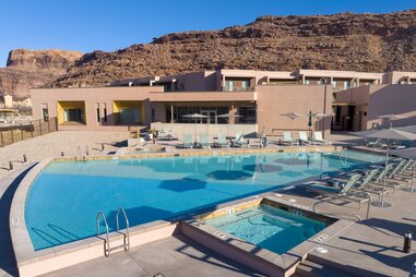 an outdoor pool at a hotel, surrounded by red rocks