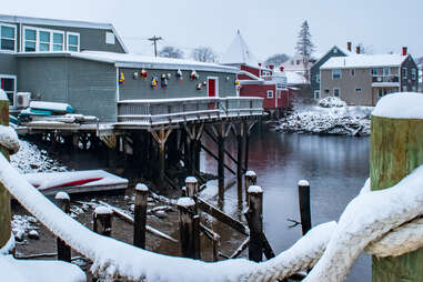 home pier in kennebunkport harbor, maine during a snowstorm