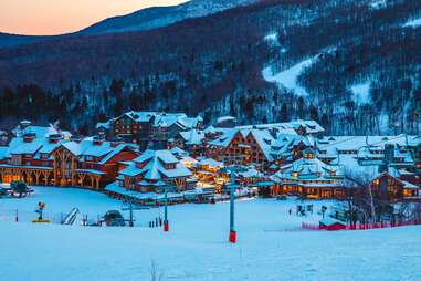 panoramic view of stowe mountain resort covered in snow at sunset