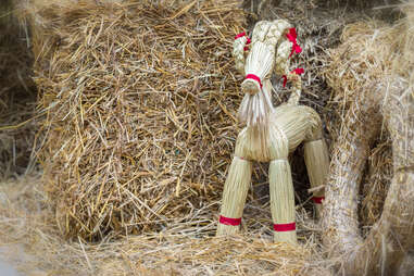 toy julbock goat in hay