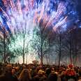 crowd in sweden watches fireworks beside gavle yule goat sculpture