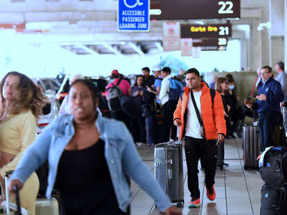 Arriving travelers wait for ground transportation during the busy Christmas holiday season at Orlando International Airport on December 28, 2022 in Orlando, Florida.