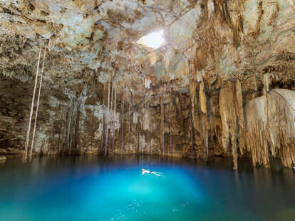 Man swimming in a cenote in Yucatan, Mexico