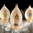 close up of glass blown ornaments containing christmas figurines