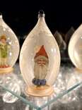 close up of glass blown ornaments containing christmas figurines