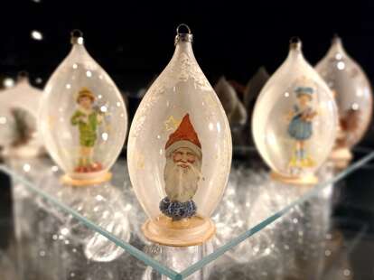 close up of glass blown ornaments containing christmas figurines