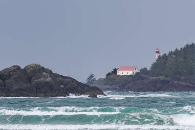 A lighthouse sticks out of the rough waters off Vancouver Island, Canada.