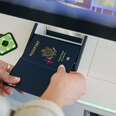 close up of hands scanning passport at airport
