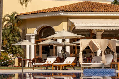 view of lounge chairs by the pool at casa velas