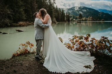 couple at wedding by water and mountains