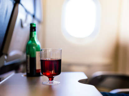 Plastic cup of red wine in the airplane.