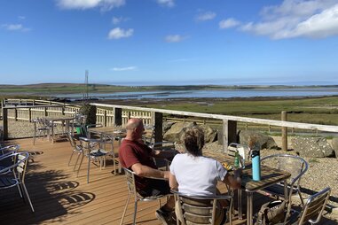 couple looking out at oyster farm