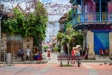 colorful buildings lining a narrow street in cartagena