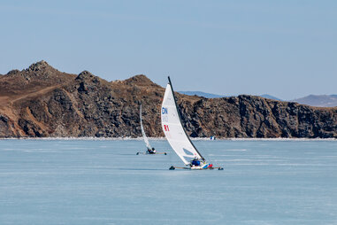iceboats, frozen lake, mountains